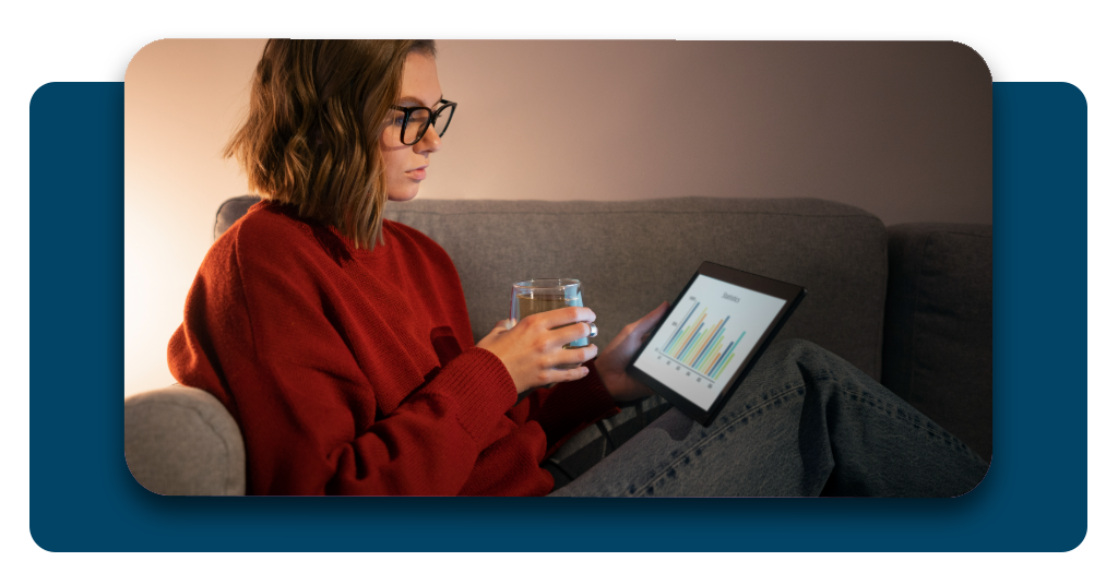 Person reviewing a digital credit report on a tablet featuring positive financial growth charts