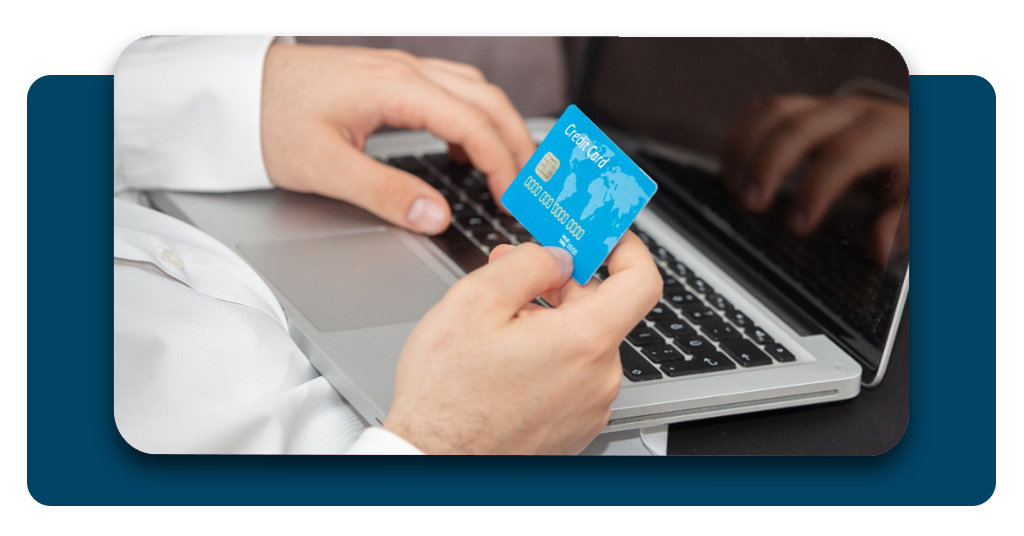 Person entering credit card details on laptop computer