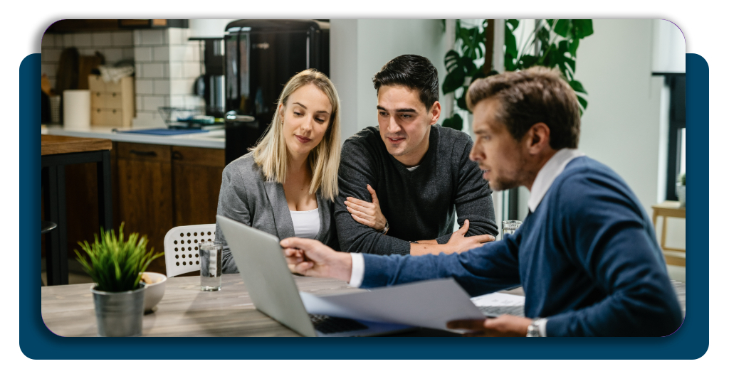 A professional consultant explaining mortgage documents to a young couple