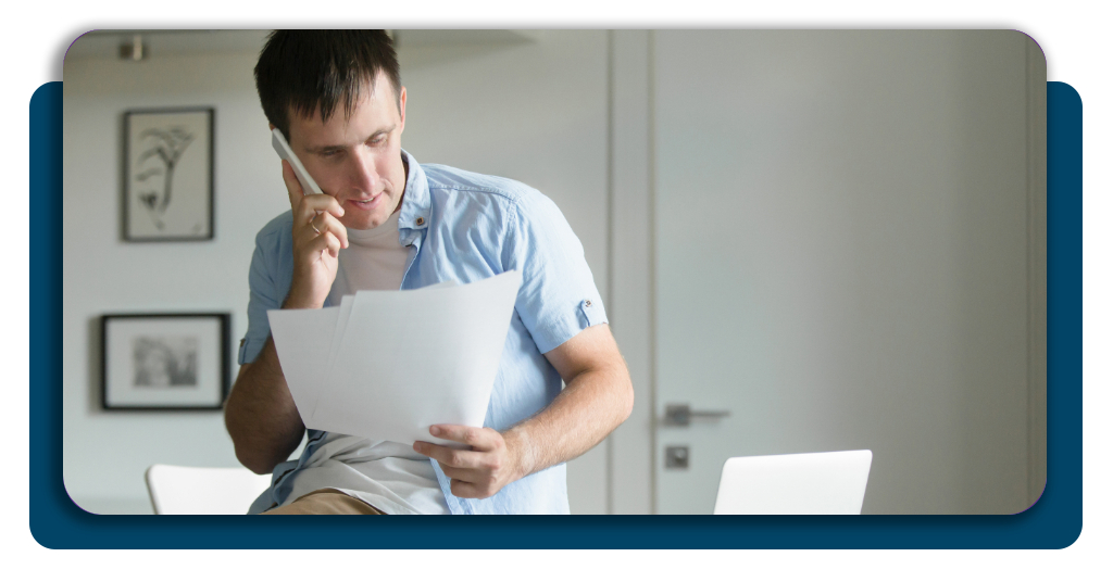 A person looking at a hospital bill with a Voucher Approved stamp appearing over the total
